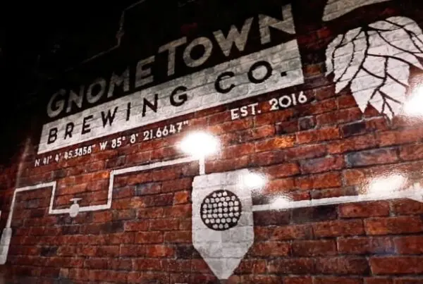 Gnometown Brewing Co. logo on a brick wall