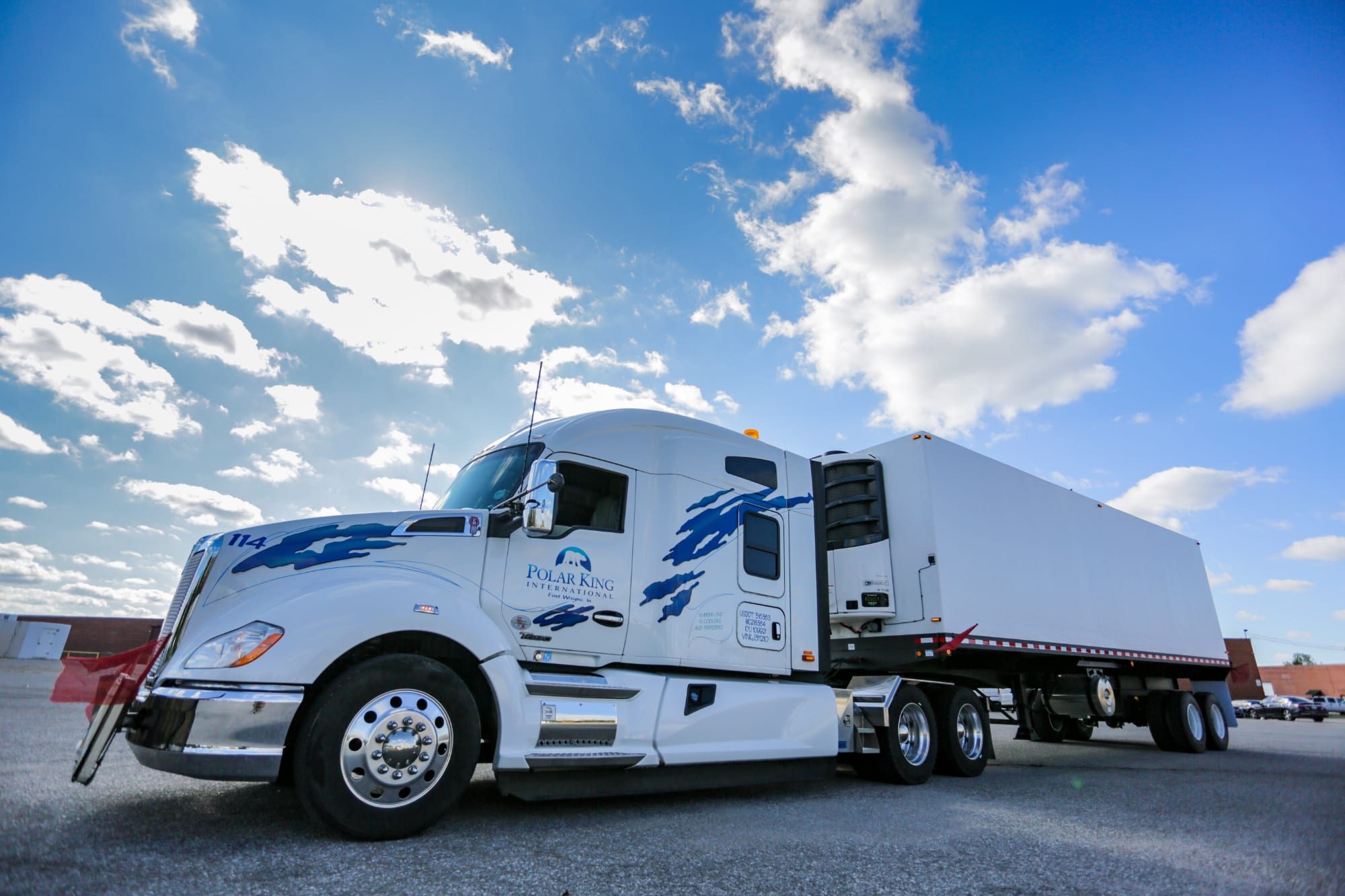Large white truck pulling a refrigerated trailer