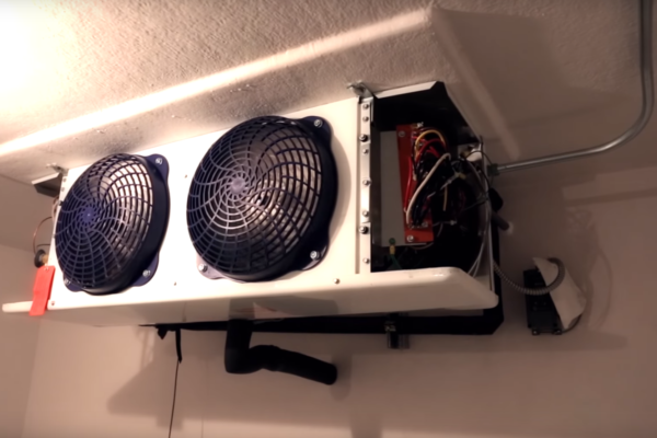 Black fans on the inside of a walk-in cooler freezer