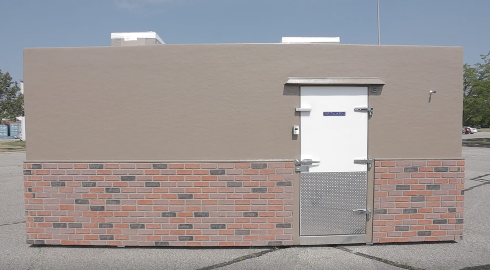 Polar King walk in cooler with brown siding and bricks with brown painted overlay