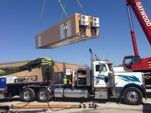 walk in cooler being positioned by crane